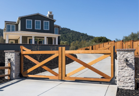 wooden driveway gate with stone pillars on each side